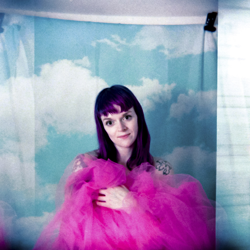 Studio portrait of Amanda with pink tulle in front of sky backdrop - shot in bulb mode with Strobe flash